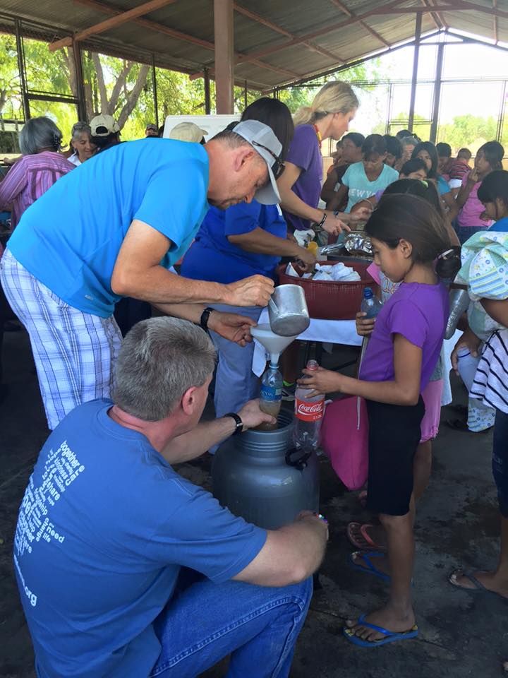 Pastor Steve serving food to villagers