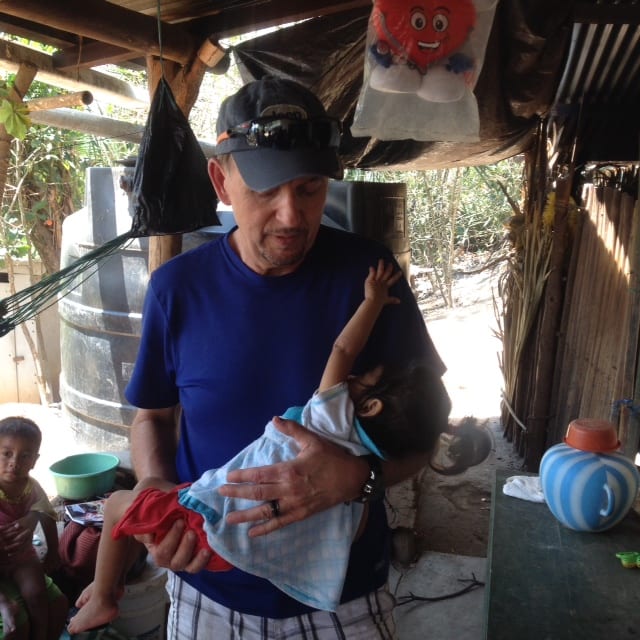 Pastor Steve holding sick infant